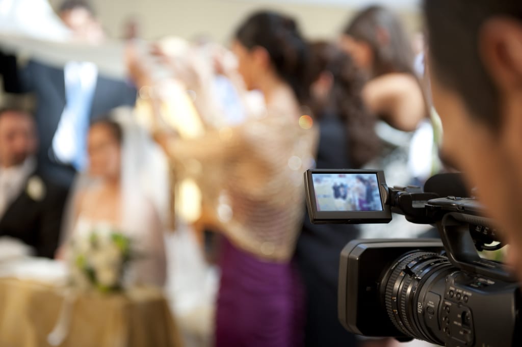 photographer shooting wedding video | filming home movies