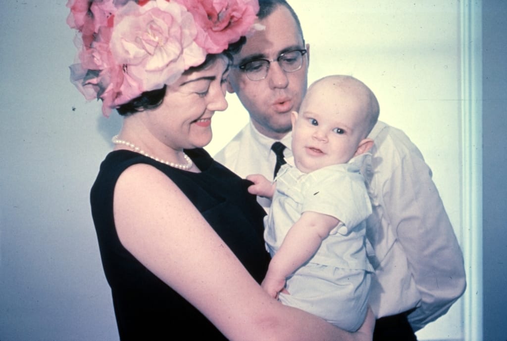Taken in 1962 we don't know what's better - the look on this boys face or his mother's hat!