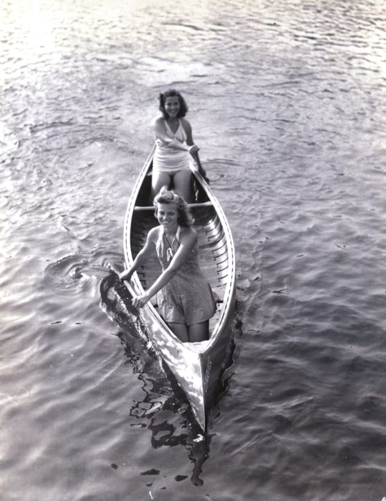 A 1930's snapshot of two girls and their canoe