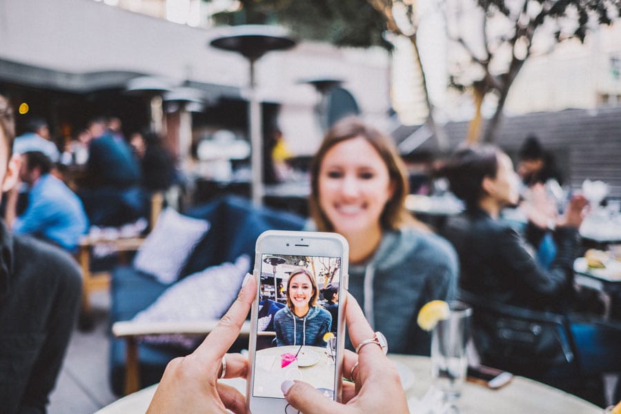 taking cell phone photo of girl