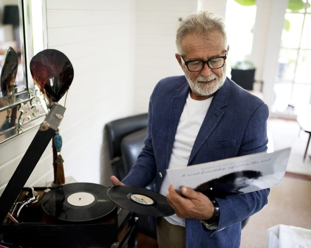 Man playing 33 rpm vinyl record