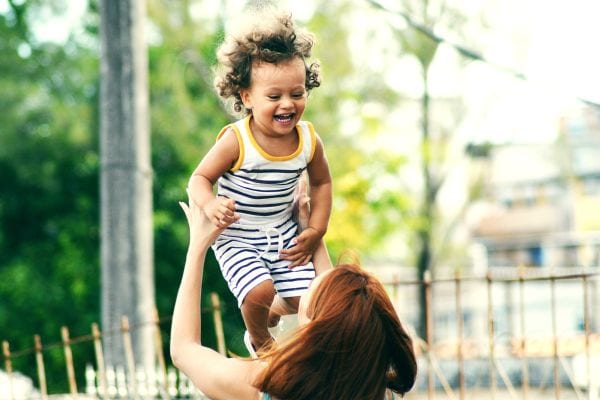woman lifting laughing child
