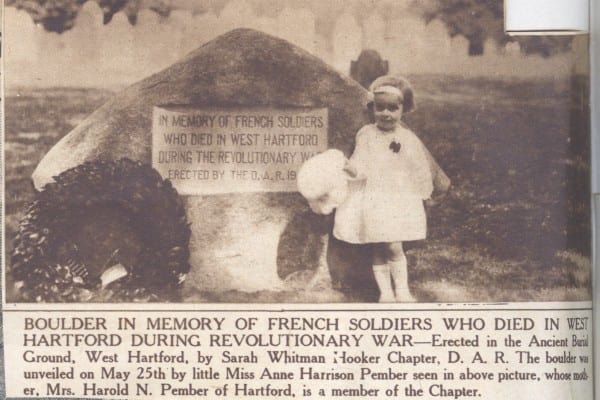 newspaper clipping of girl standing in front of a CTDAR WWI memorial