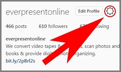 screenshot of the Instagram desktop site Profile section with an arrow pointing to the Settings icon
