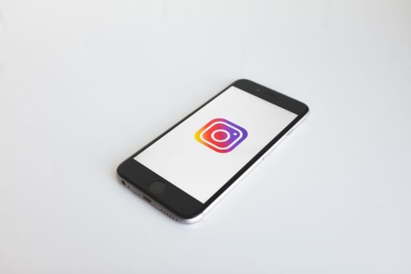 a smartphone displaying the Instagram logo on screen