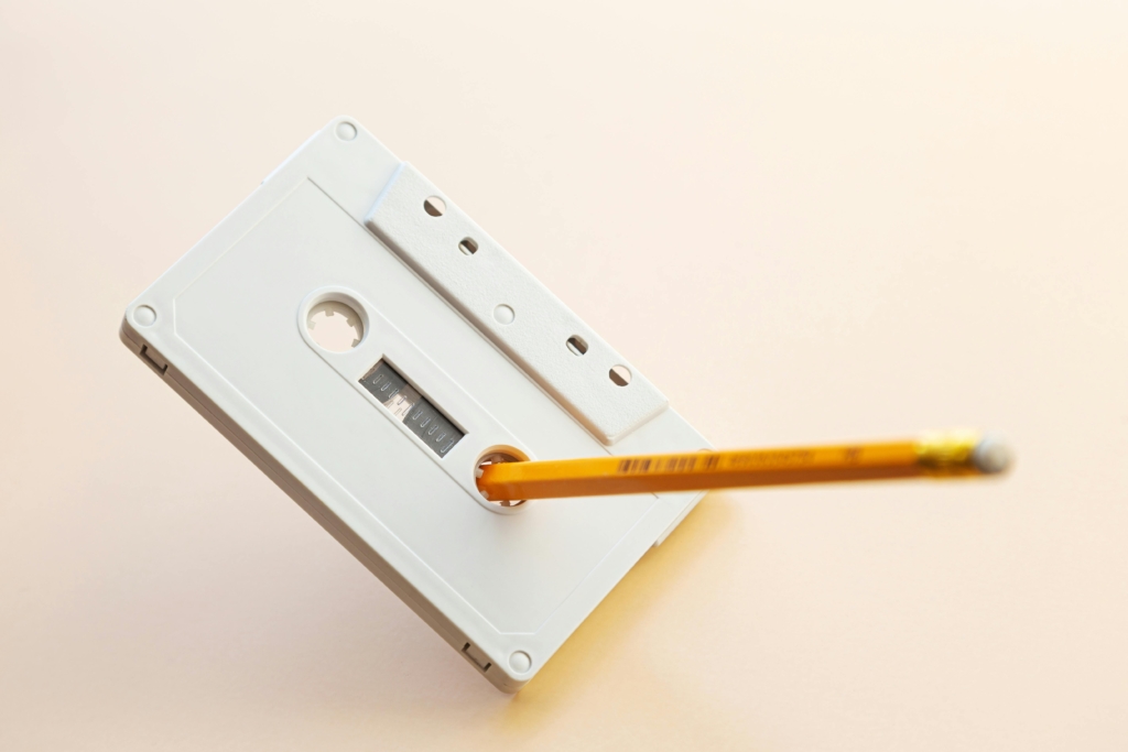 rewinding a cassette tape with a pencil