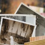 Close-up of a stack of vintage photographs displaying historic scenes.