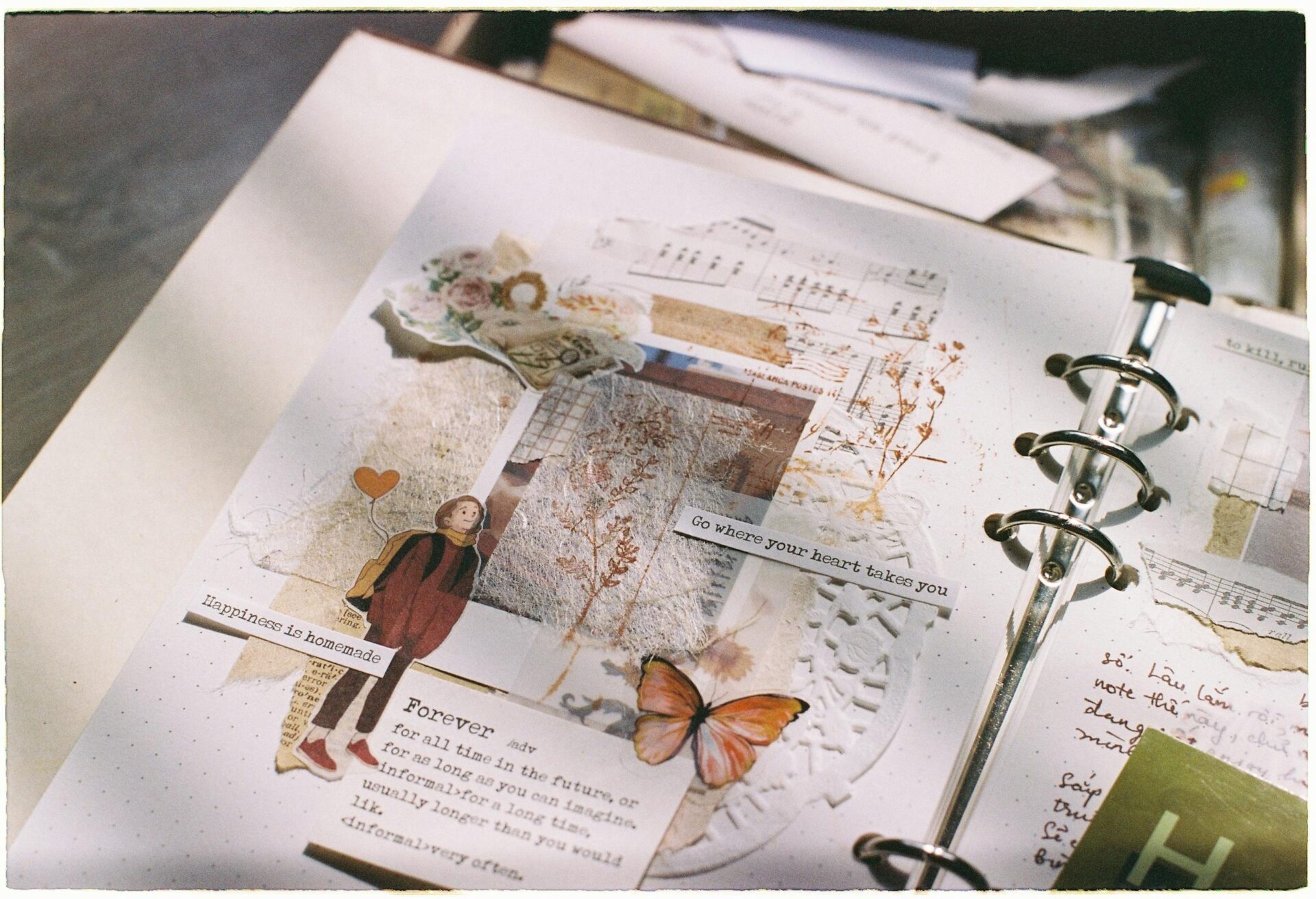 A beautifully decorated scrapbook page with vintage elements and inspiring quotes.
